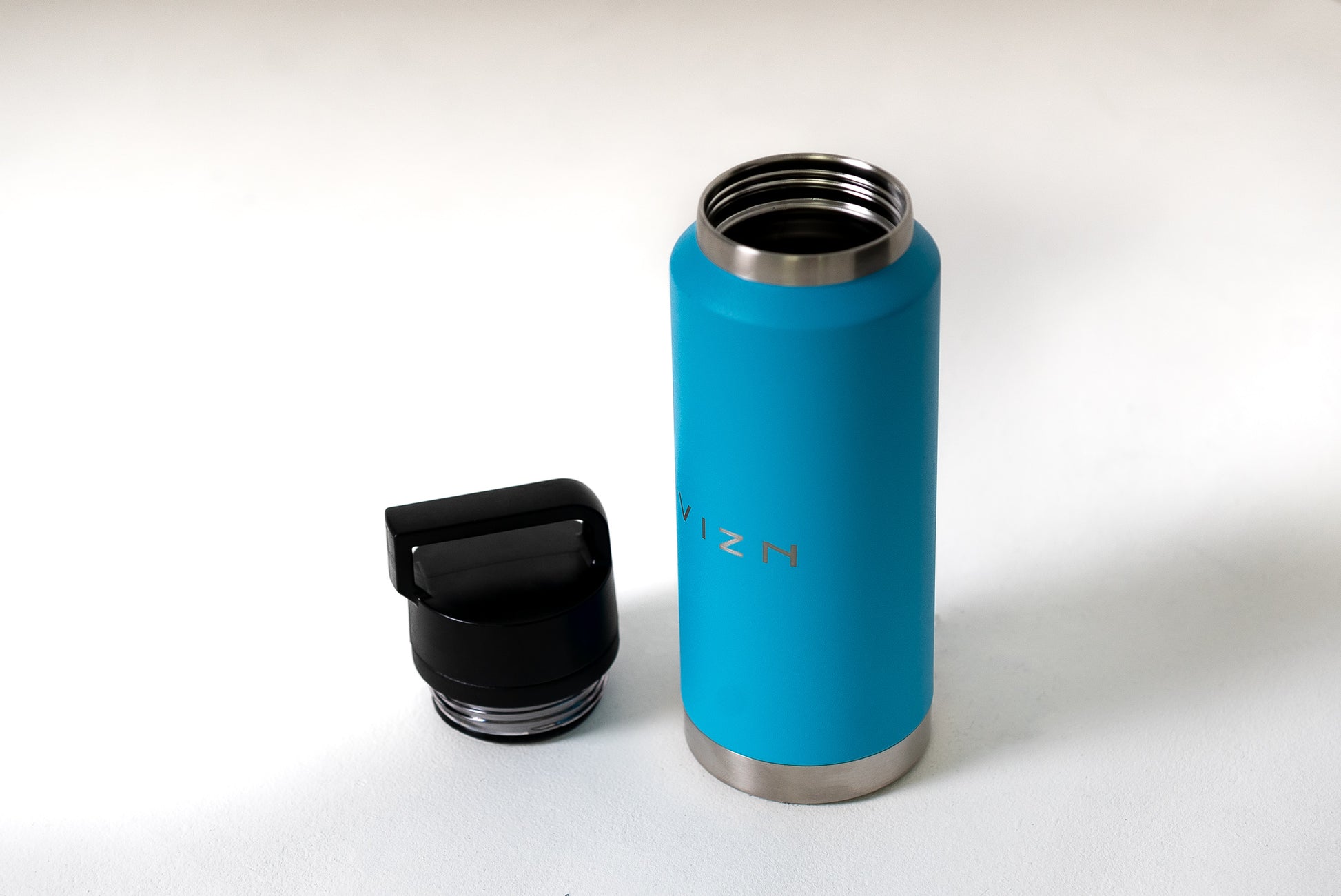 Close-up of stainless steel water bottle with vibrant colours and versatile lid options