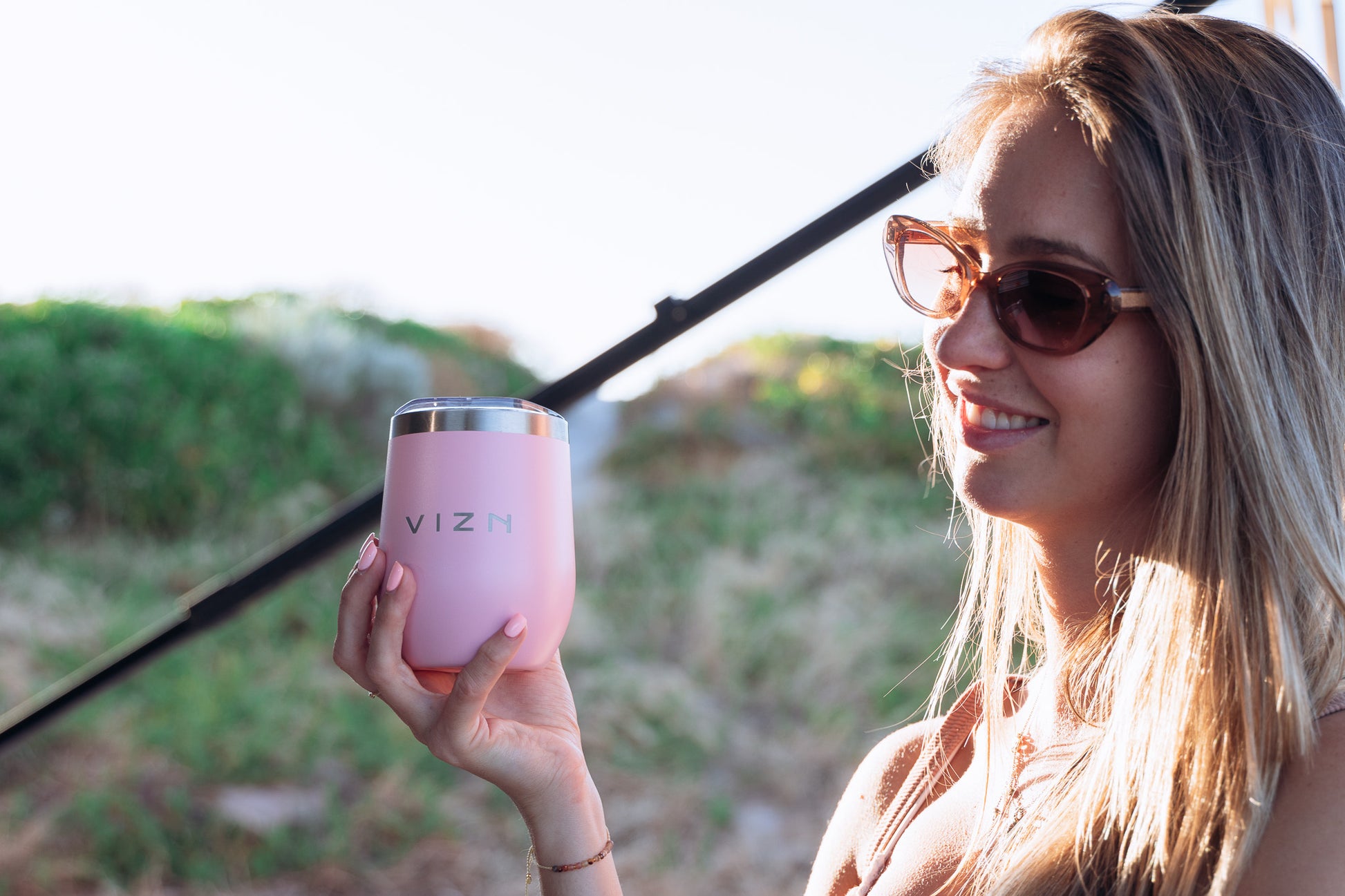 Travel mug being used camping, perfect for keeping your drinks cold.