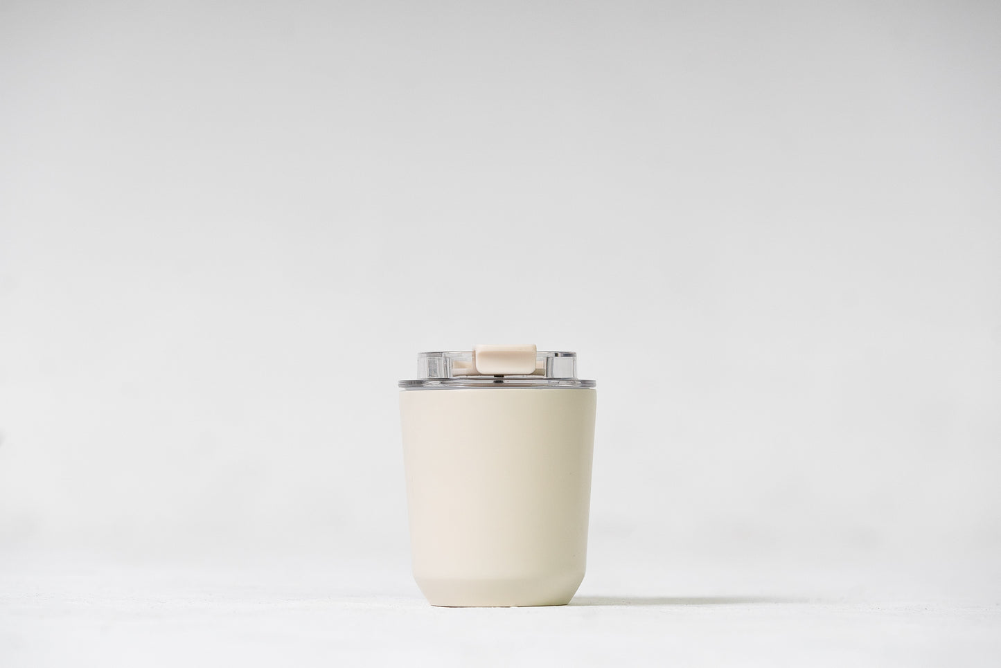 Stainless steel coffee cup that fits in standard cup holders and under coffee machines