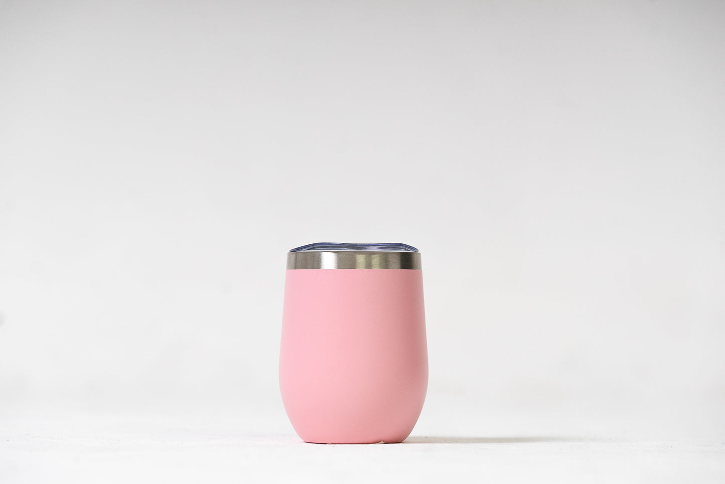 Coral Pink Sipper Tumbler with a slide lid, highlighting its spill-resistant feature.