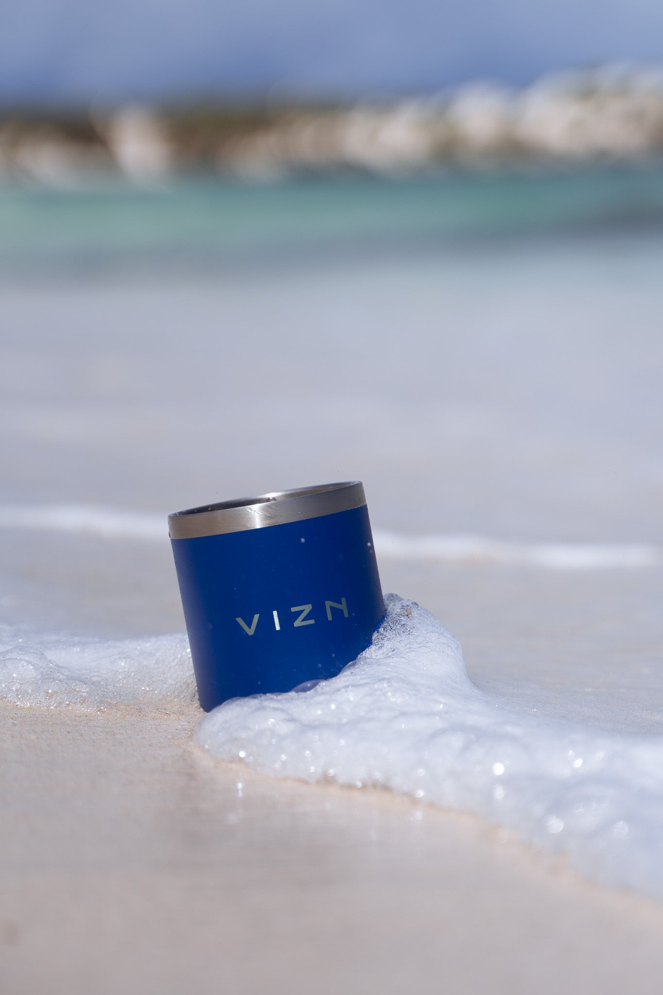 Deep Sea Blue OG Tumbler at the beach, demonstrating its versatile use for weekends and holidays