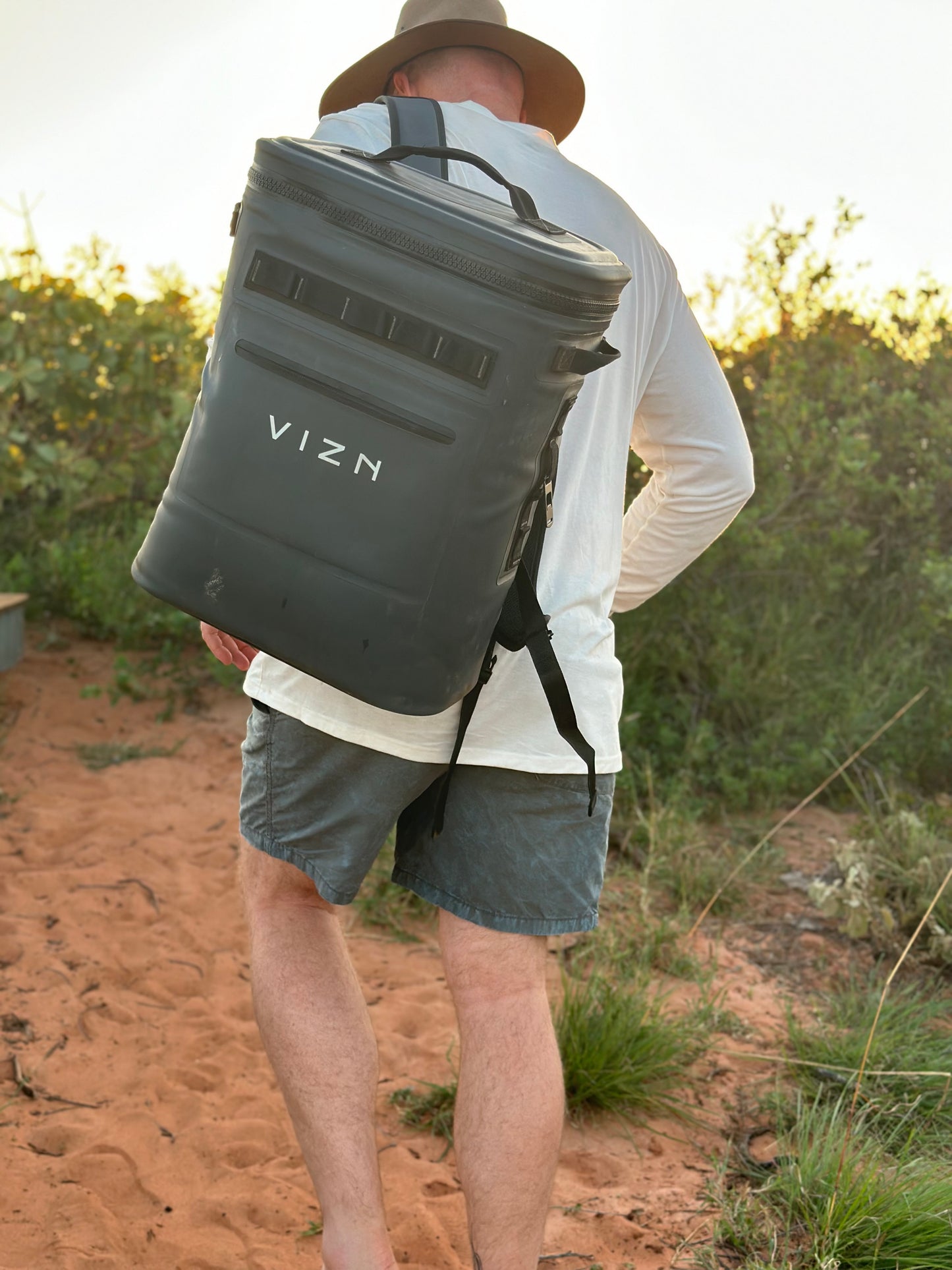 Insulated backpack cooler with padded straps and bottle opener