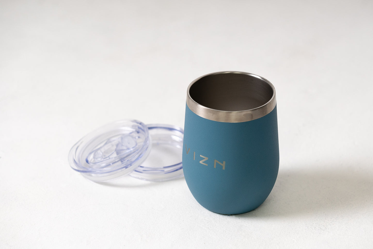 Mist Blue Sipper Tumbler with a slide lid, highlighting its spill-resistant feature.