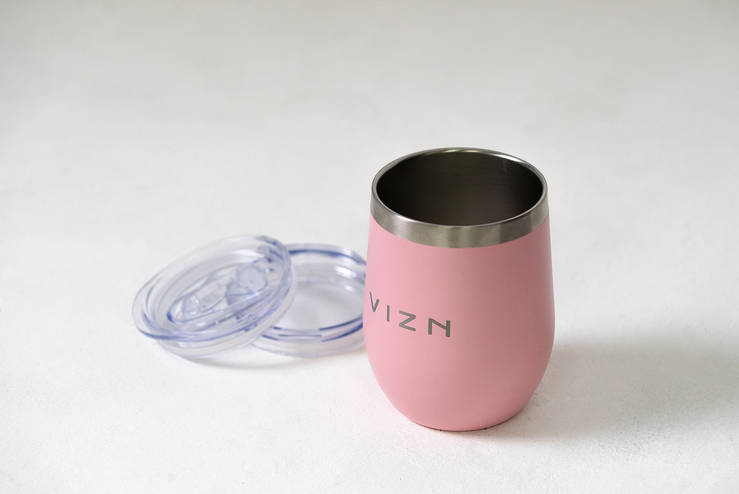 Sipper Tumbler in Coral Pink with an open spout lid, showcasing its double-walled stainless steel design