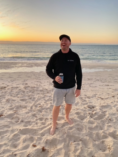 Man wearing comfortable hoodie on beach holiday.